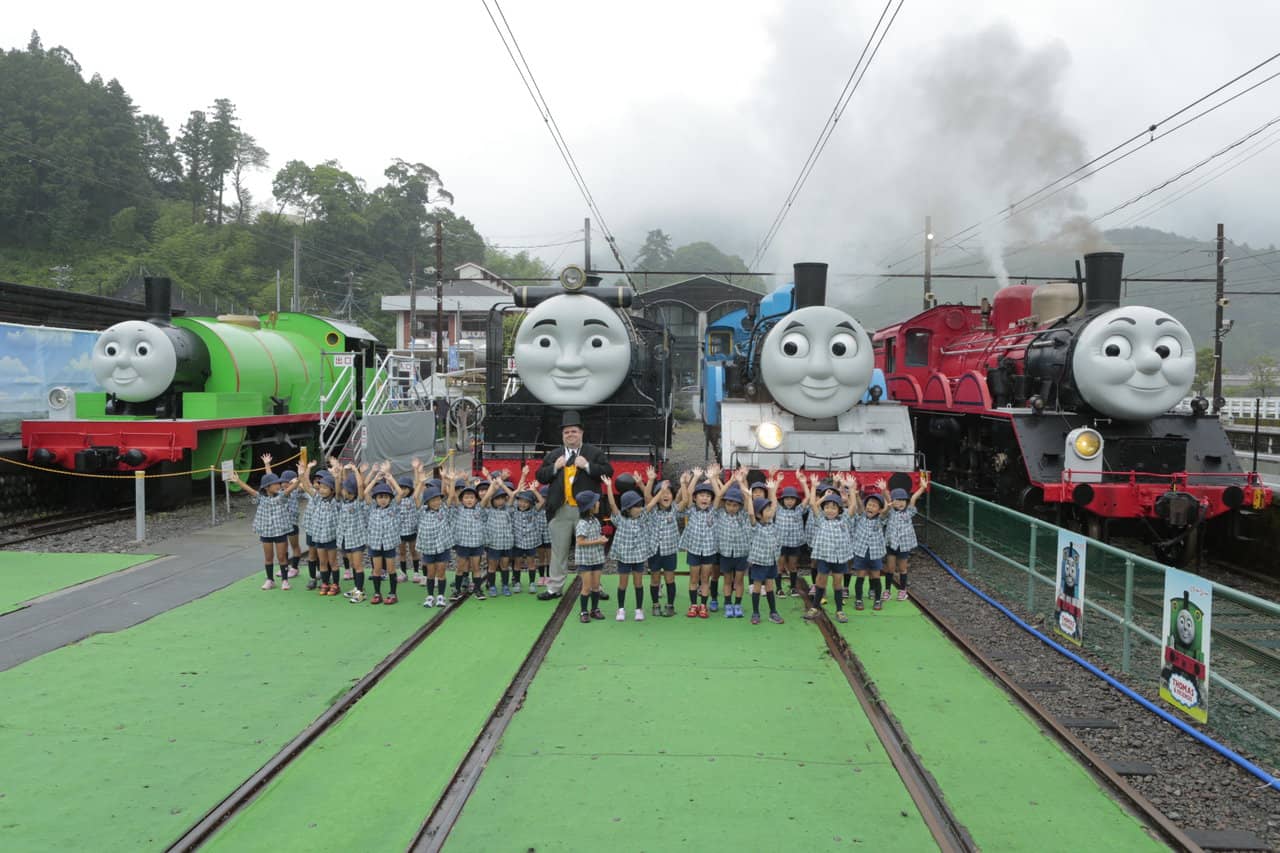 children group around with Thomas the train and friends in Shizuoka Oigawa Railway in Japan