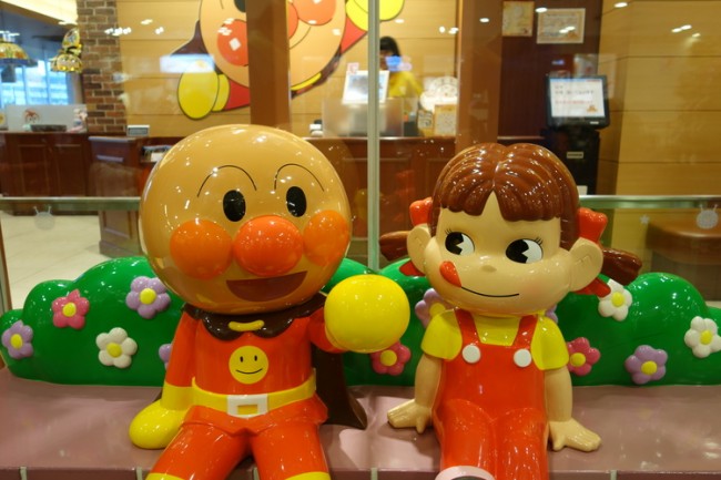 anpanman sitting with the mascot of fujiya cakes