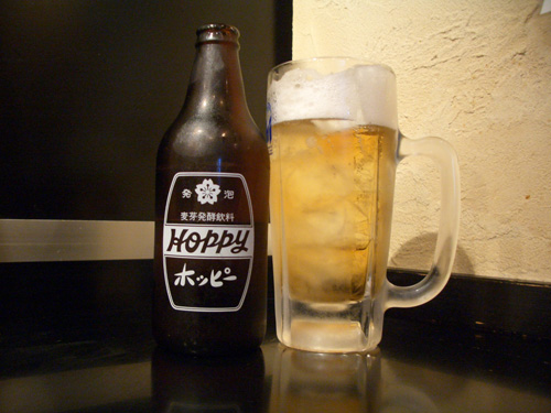 A bottle and glass of Hoppy, a drink similar to beer that has a very low alcohol content, good for all seasons.