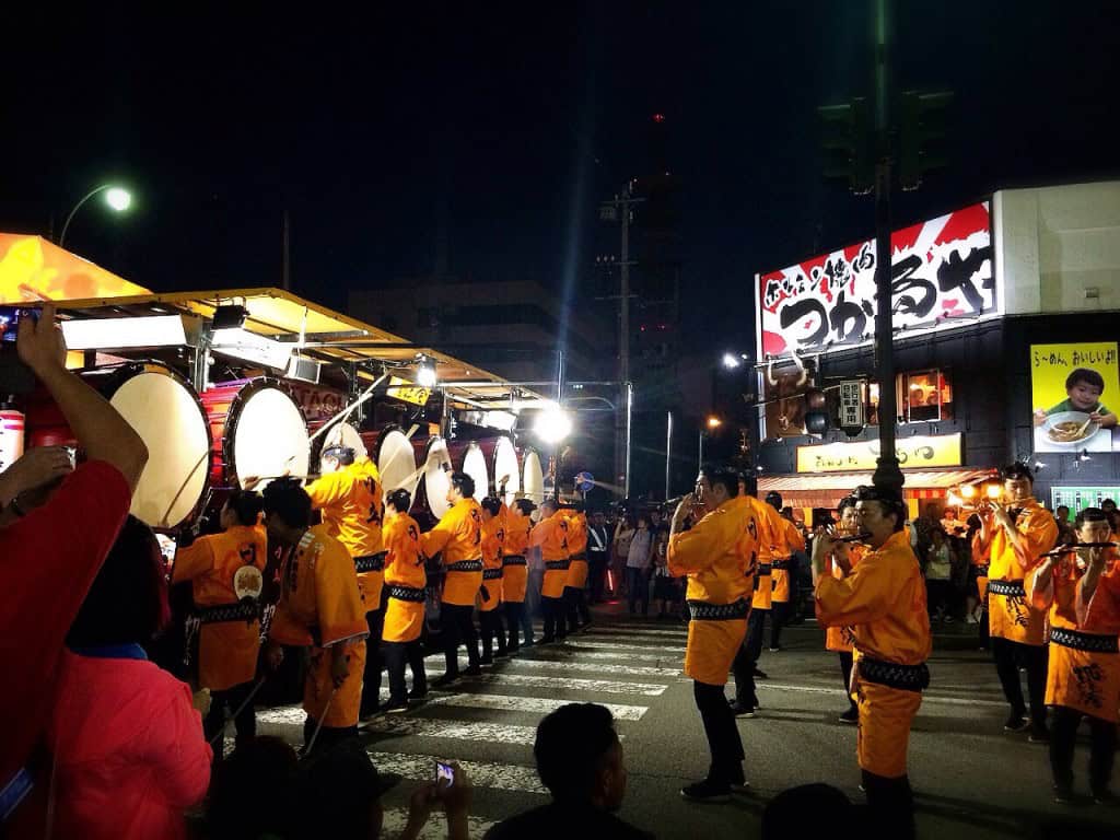 Performers dressed in yellow at the Nebuta Matsuri Festival.