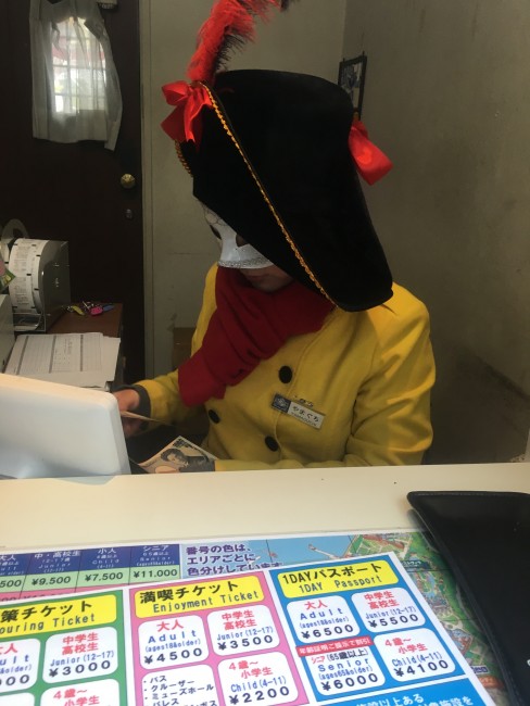 Ticketing counter staff with mask at Huis Ten Bosch.