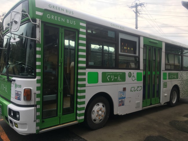 A white and green bus on Nokonoshima