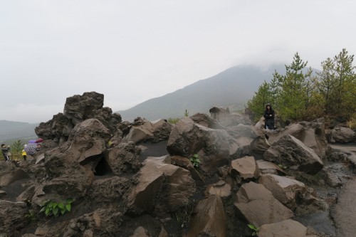 Volcanic boulders giving off steam along Sakurajima lava road