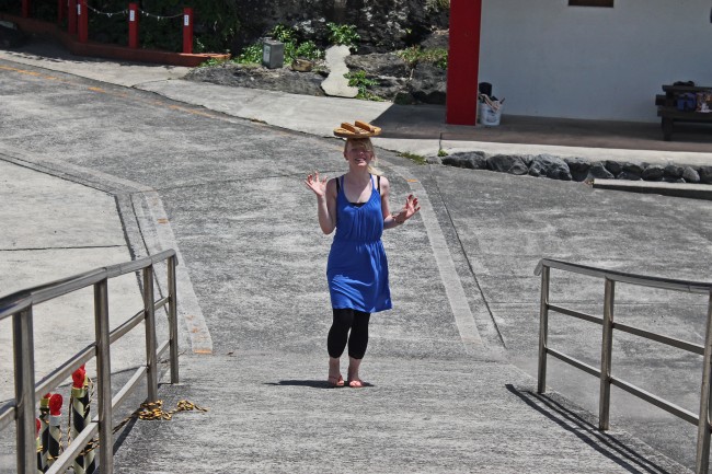 Person at the bottom of a ramp with the lid on her head at Kamafuta Jinja in Kagoshima.