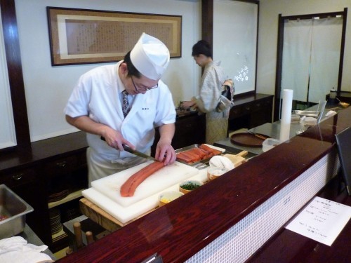 Chef preparing salmon and other food at Shintaku, in Murakami.